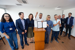 Prefeito Sebastião Melo e vereadora Fernanda Barth mostram documento de sanção